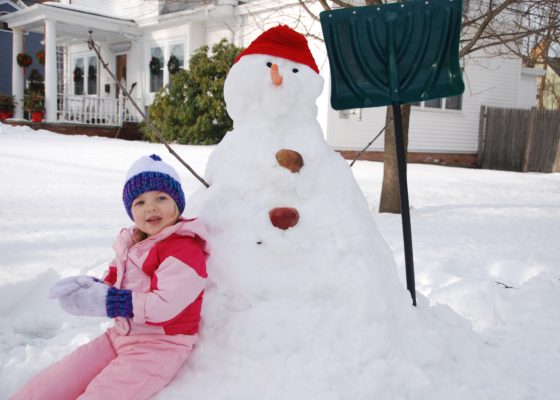 Eva seated by snowman