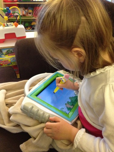 Eva writing her letters with the iLearn Learning Tablet