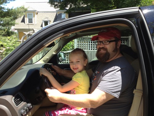 Eva pretending to drive the GMC Sierra Denali