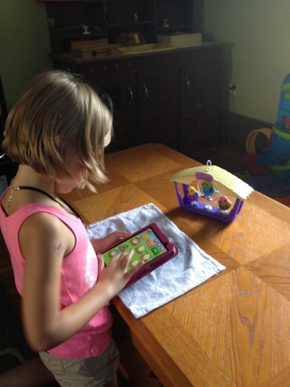 Eva using the Digibirds app on her tablet