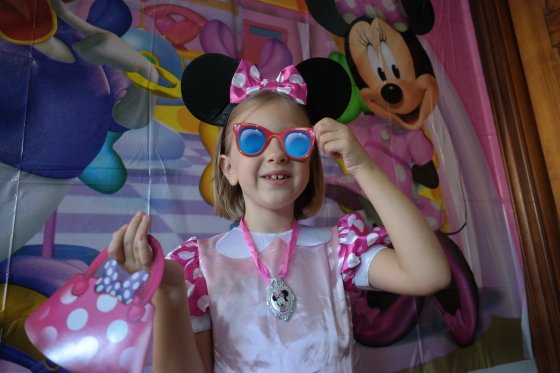 Posing at the Minnie Mouse Photo Backdrop