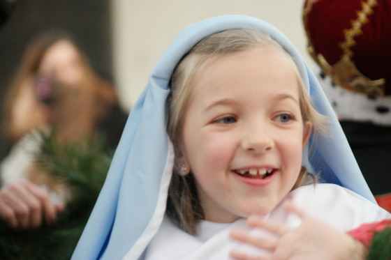 Eva smiling ear to ear as she is Mary on her School Float
