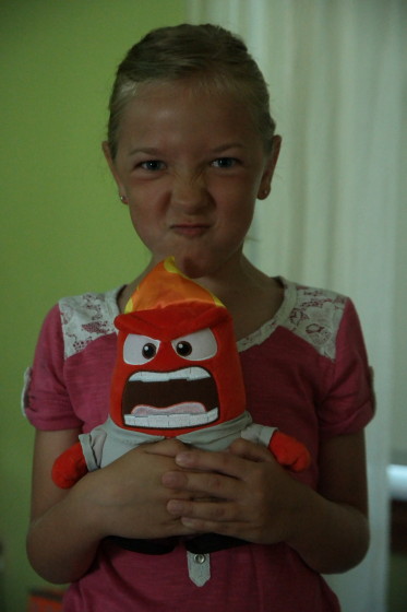 Eva holding Talking Plush Anger from Inside Out