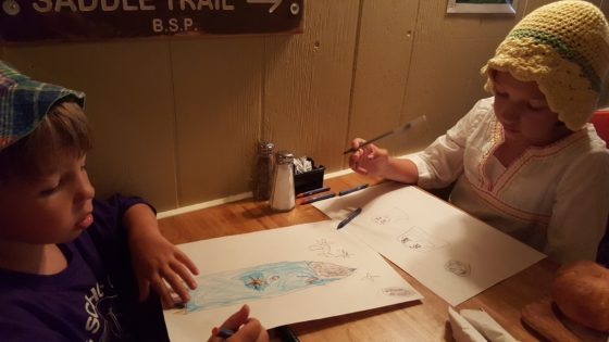 The kids enjoying drawing at dinner