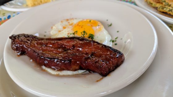 Candy Laquered Bacon Strip with a fried egg
